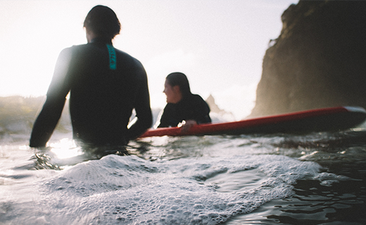 surf lessons 5 two people with surfboards in a surf lesson